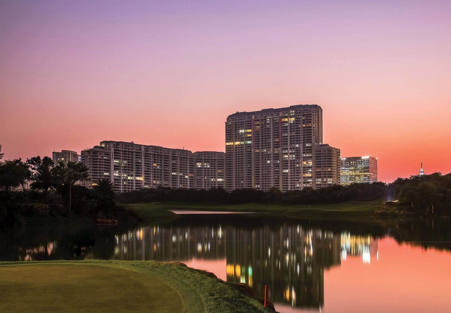 Towers mirrored in the golf course lake at dusk