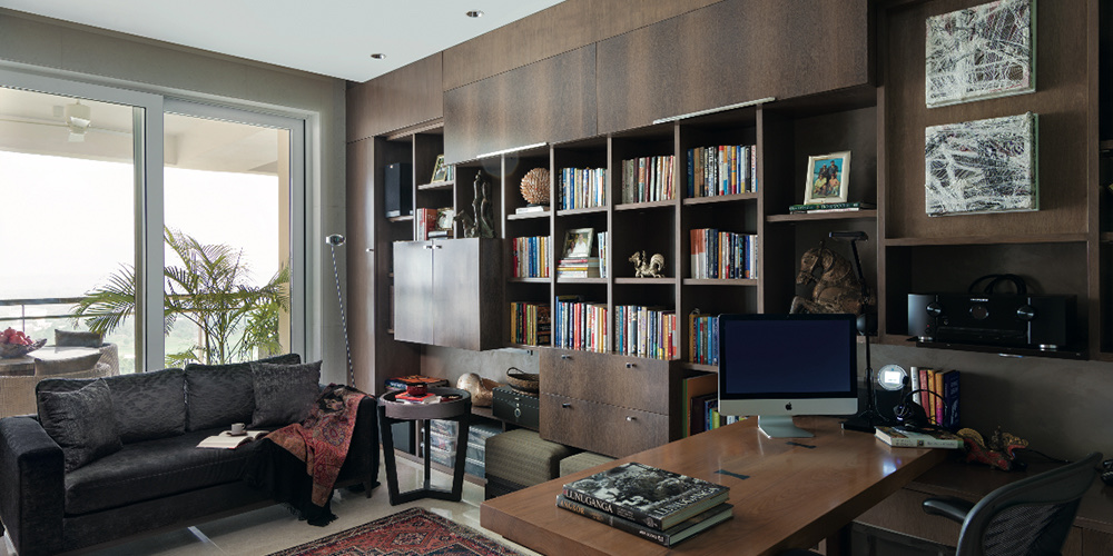 Study lined with walnut shelving