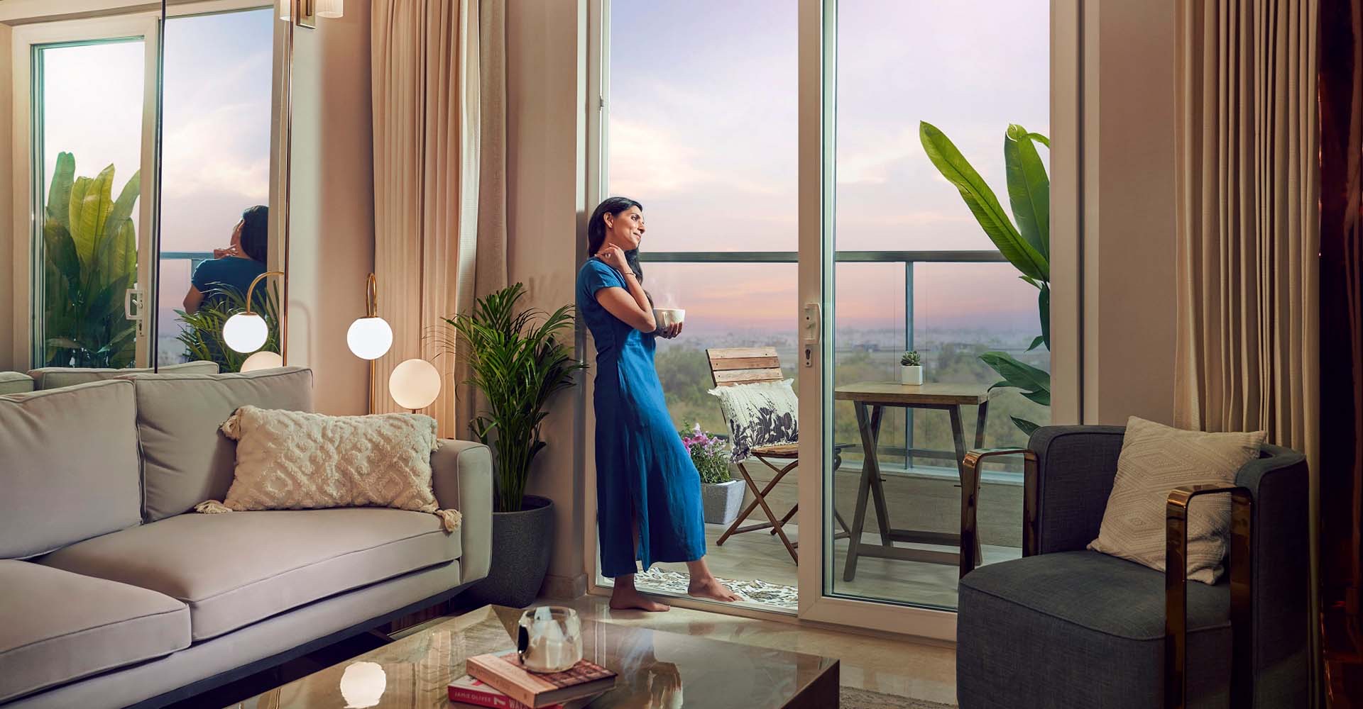 Living room opening onto a balcony with township views