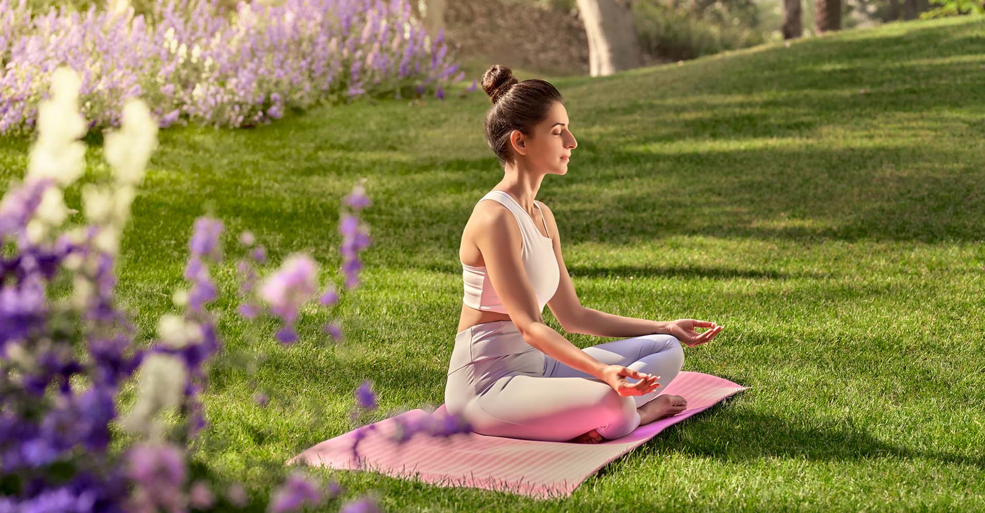 Yoga on a flowering lawn within the township