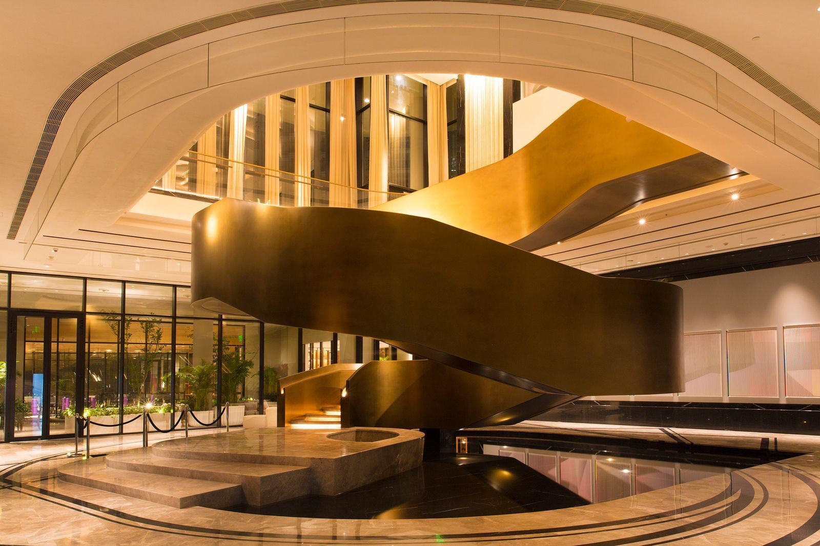 Sculptural spiral staircase in a double-height lobby
