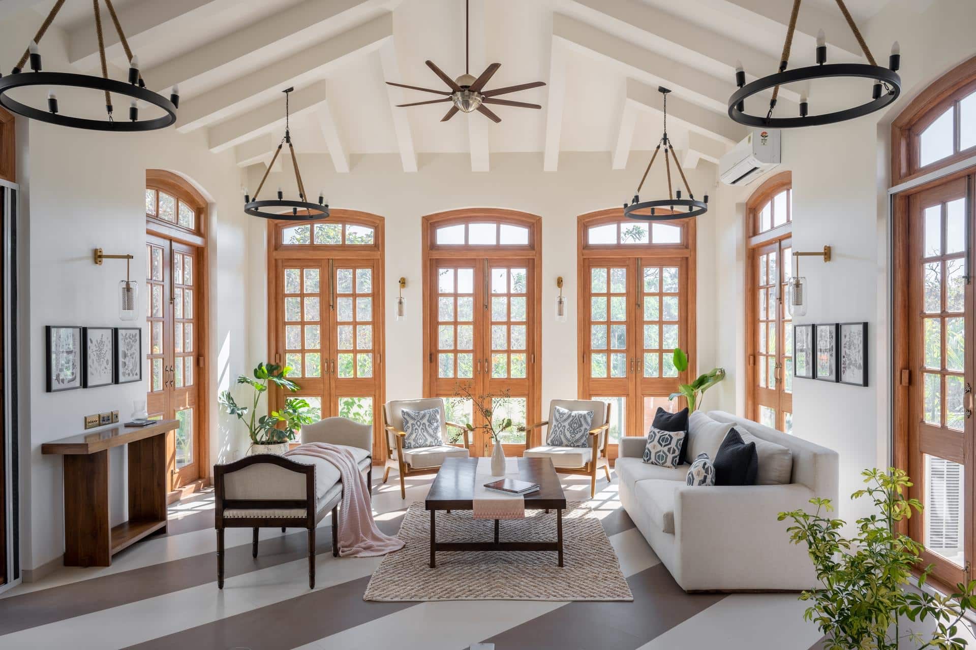 Double-height living room with arched timber doors (Isprava Villa Sobreda)