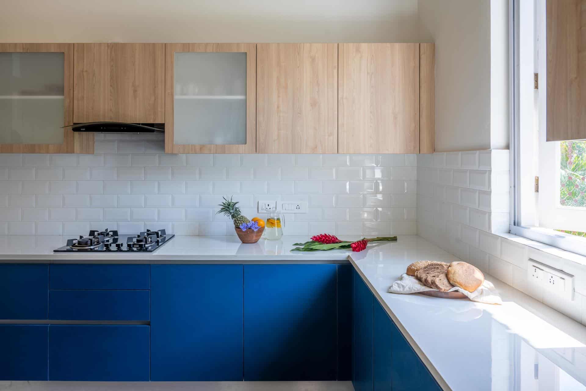 Kitchen with cobalt cabinetry and garden window (Isprava Villa Sobreda)