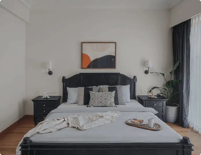 Calm bedroom with dark timber bed and linen